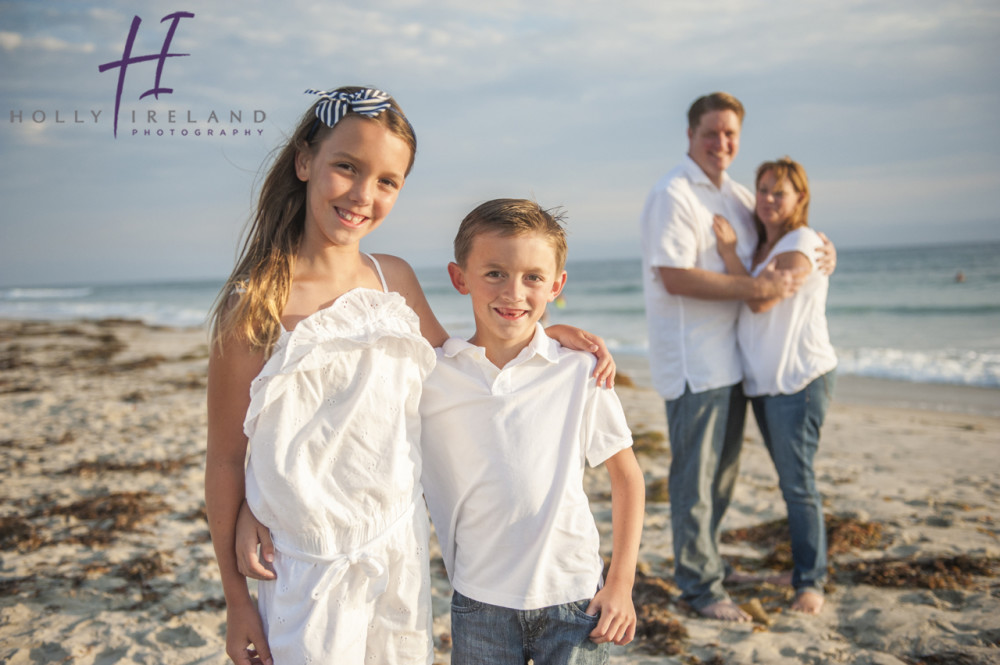 Adorable family photos with the kids in the front at the beach in Carlsbad Ca