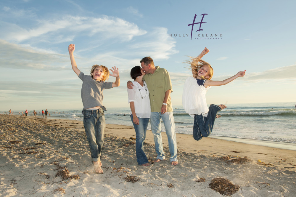 Fun jumping family at the beach in San Diego CA