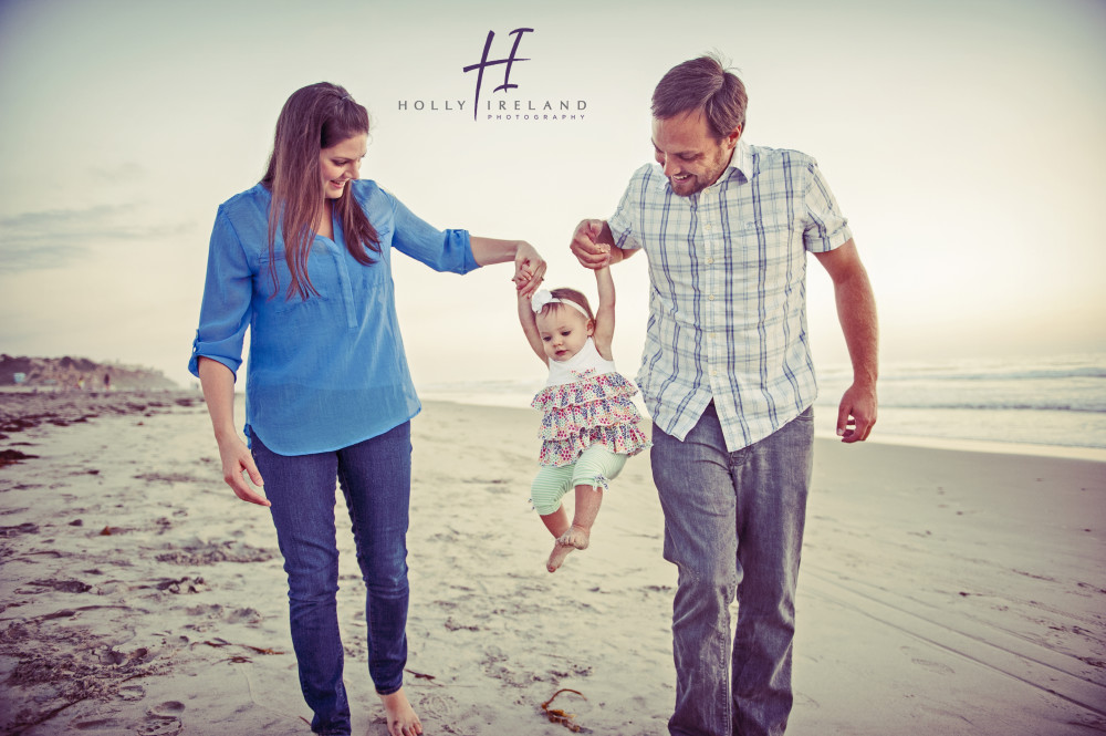 Fun family with a baby photographed on the beach in Carlsbad San Diego cA