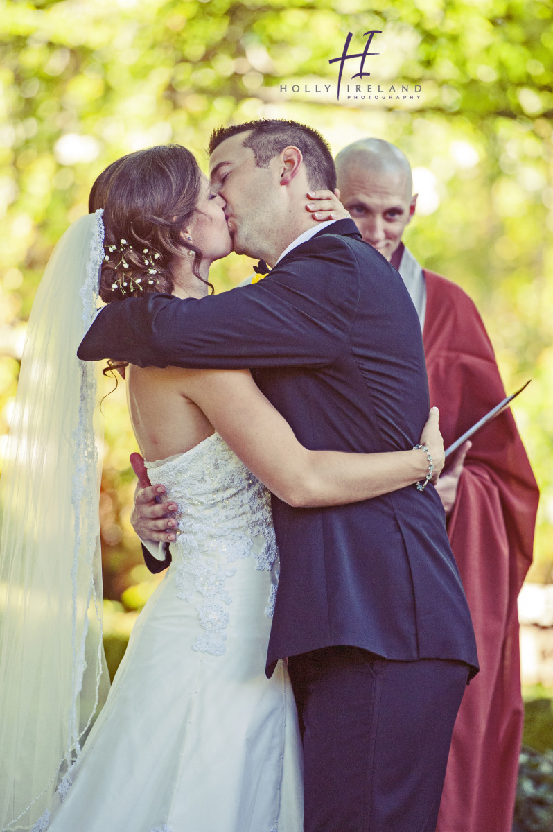 Kissing wedding photos during a ceremony in Napa