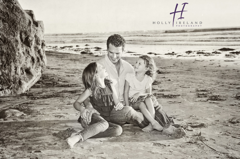 father and daughters at the beach in San Diego