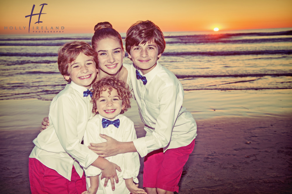 adorable siblings for holiday photos at the beach at sunset