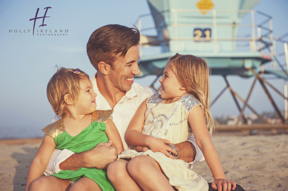 dad and daughters at the beach in San diego photos