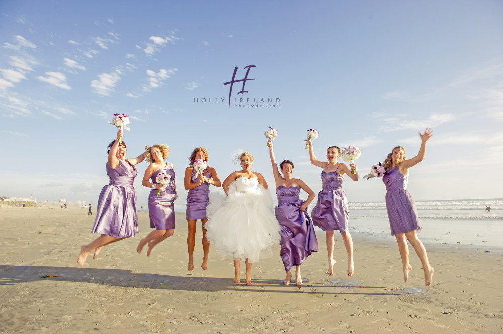bridal party jumping a the beach