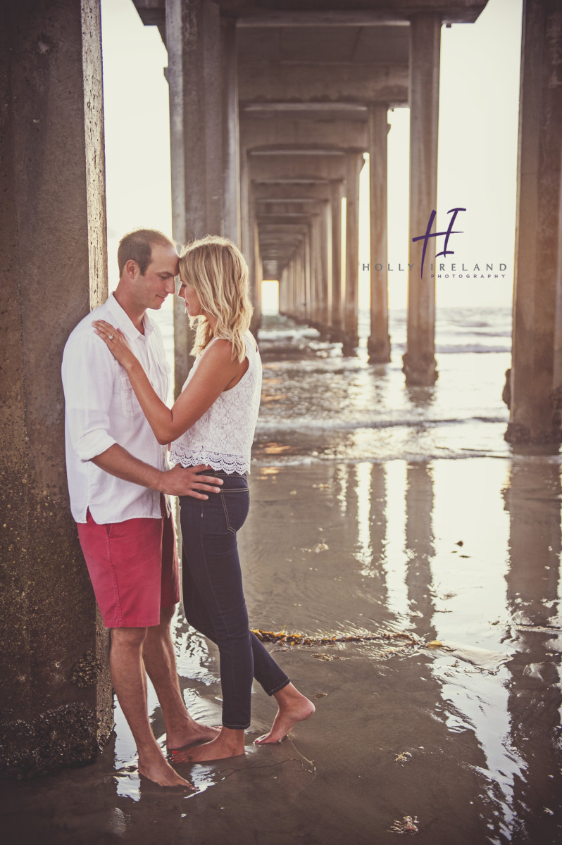 Susnet beach engagment photos under a pier