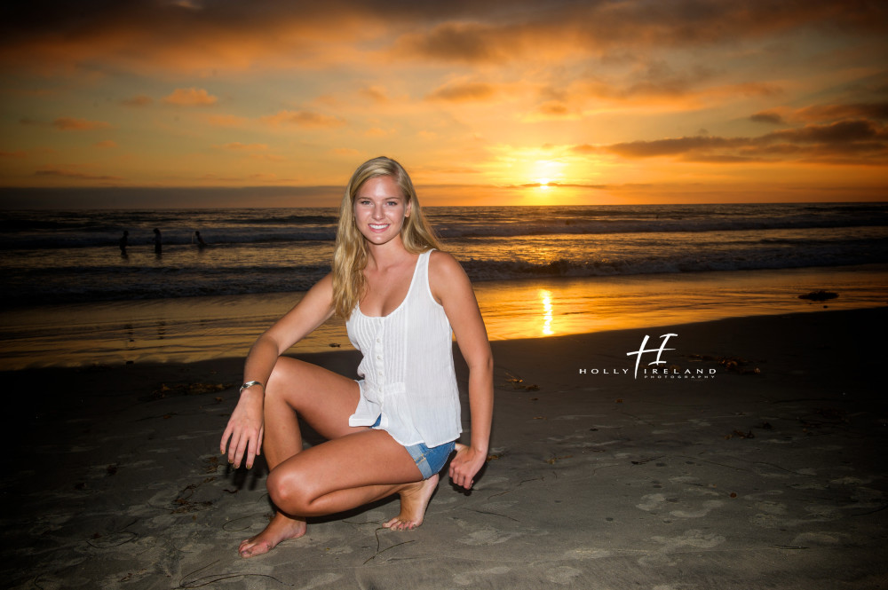 high school senior at the beach with a pretty sunset