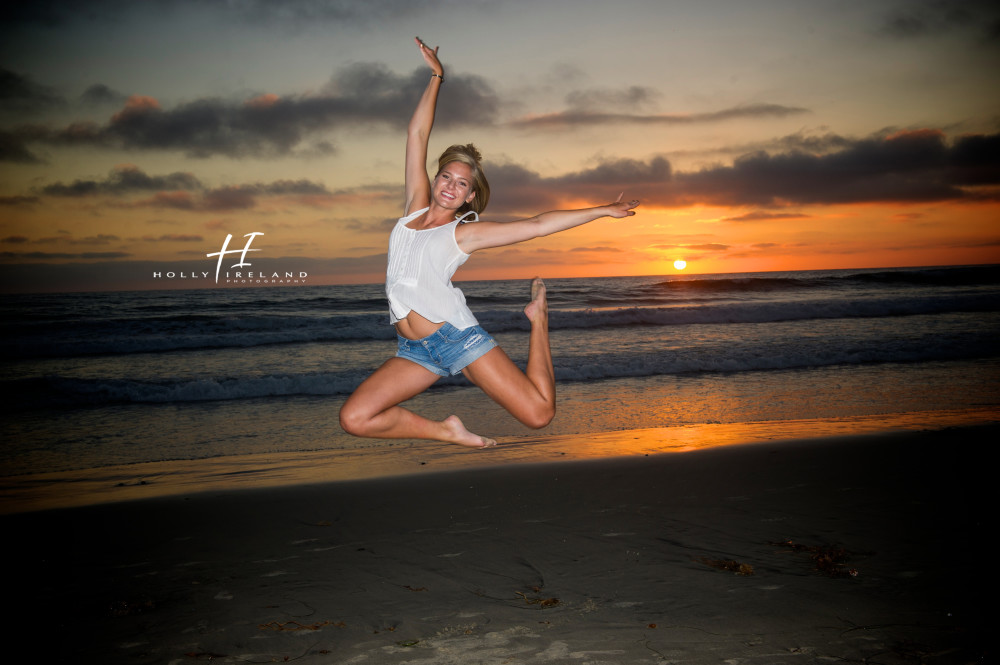 high school senior at the beach with a pretty sunset