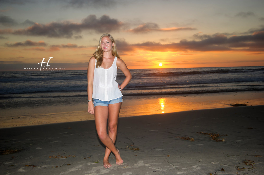 high school senior at the beach with a pretty sunset