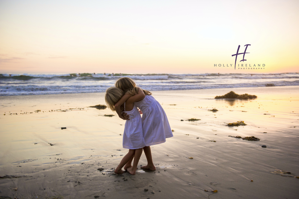 siblings at the beach at sunset photos